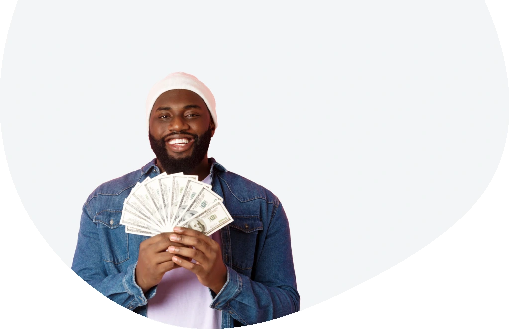 Smiling man showing $1,000 in cash received from a payday loan