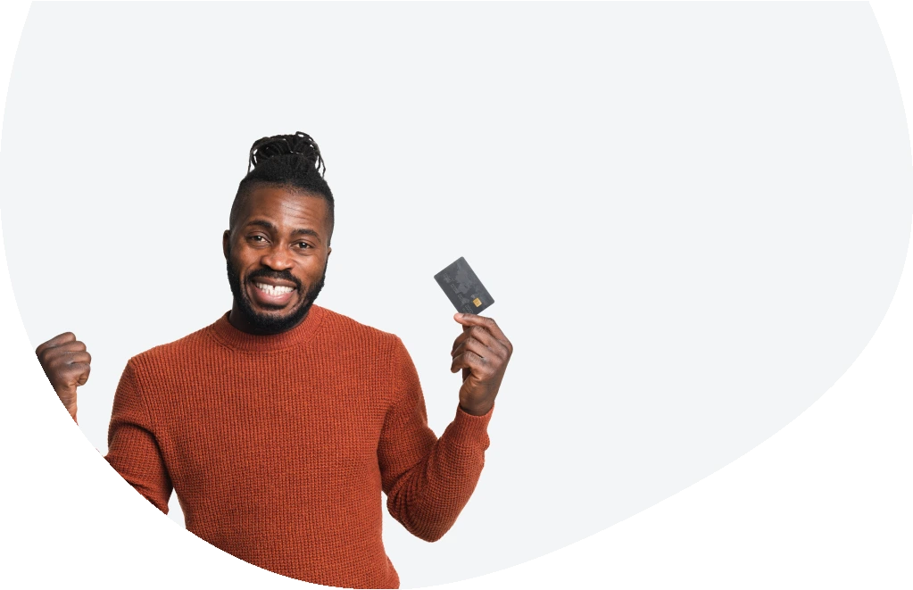 Young man holding his credit card after applying for an emergency loan
